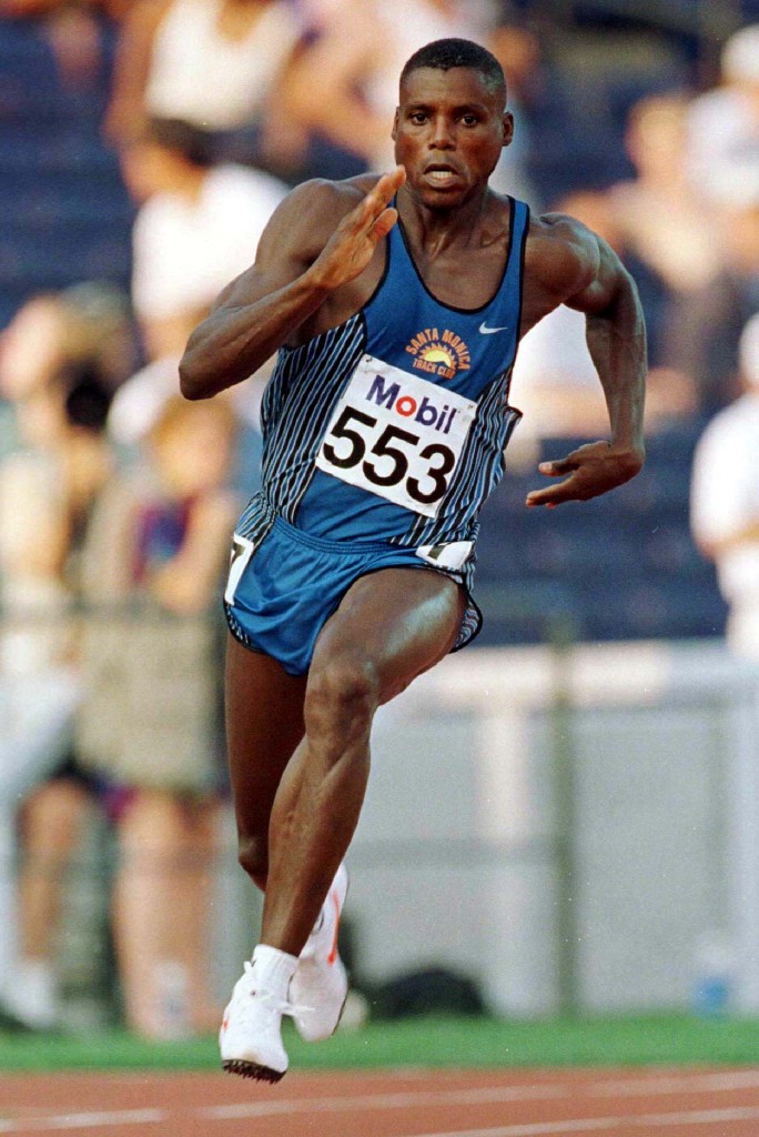 Carl Lewis races through a turn during his heat in the ...